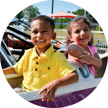 Two Guests Smile On The Sky Fighters Ride
