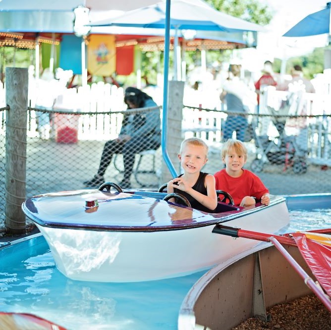 Two boys float on the boat ride.